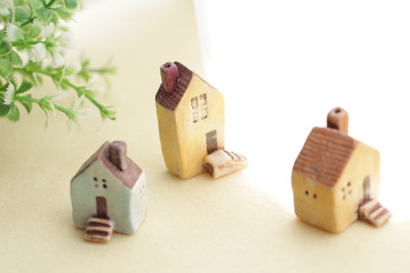 A cute little miniature house placed by a window where light shines inの写真素材