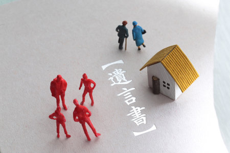 A photo showing inheritance troubles using miniature dolls, a house, and textの写真素材