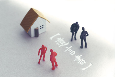 A photo showing inheritance troubles using miniature dolls, a house, and textの写真素材