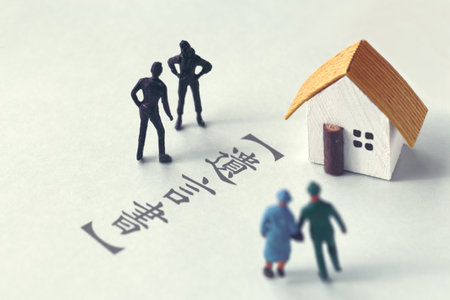 A photo showing inheritance troubles using miniature dolls, a house, and textの写真素材