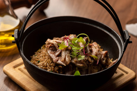 mushroom funghi duck rice risotto on a pan olive oil pepper in a pan on a wooden table