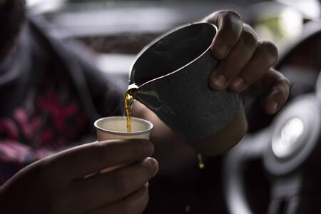 pouring brewing coffee with ceramic cup with beautiful light and depth of fieldの写真素材