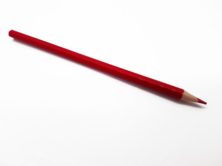 Red pencil lying on white backgroundの写真素材