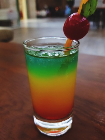 Colorful cocktail with a small cherryの写真素材