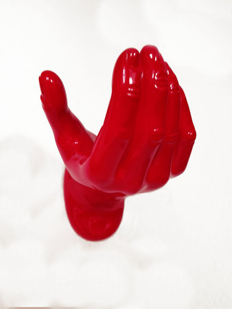 Red reaching hand on white background