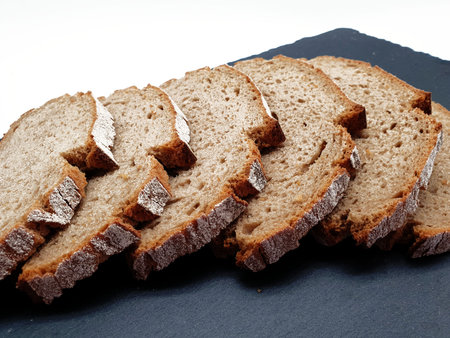 Sliced ??bread on white background on a slate plate