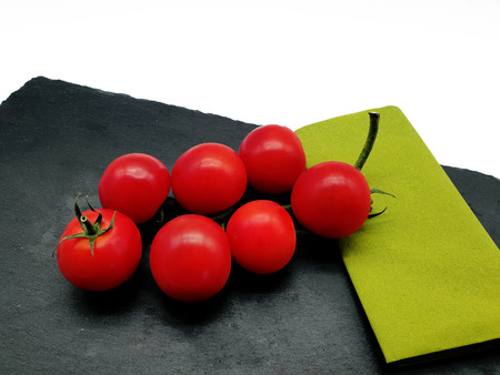 Tomato mozzarella with basil isolated on a slate plateの写真素材