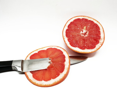 Grapefruit in slices released on a white backgroundの写真素材