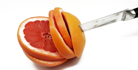 Grapefruit in slices released on a white backgroundの写真素材