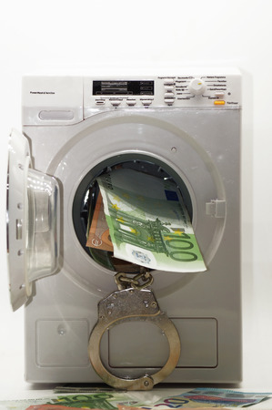Illegal money laundering black money released on white backgroundの写真素材