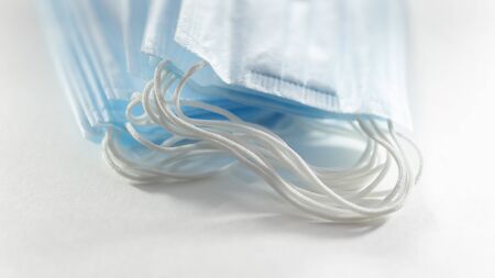 disposable blue medical mask on a white background.の写真素材