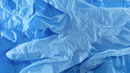 disposable blue medical gloves on a white background.の写真素材