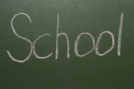 Handwritten inscription in chalk school on a green blackboard.の写真素材
