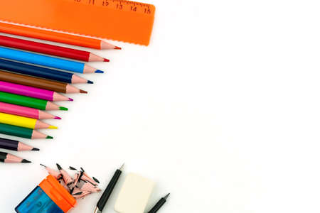 Multi-colored pencils, eraser, ruler, sharpener and compasses on a white background. Copyspaceの写真素材