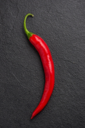 red chili pepper on slate plateの写真素材