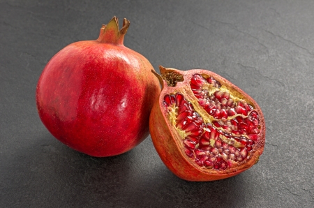 Pomegranate on a slate plateの写真素材