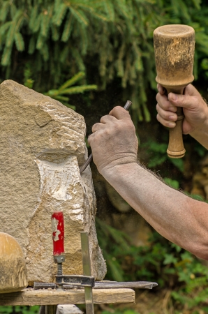 sculptor working on a stone sculptureの写真素材