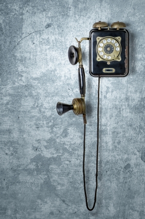 antique telephone on a grungy blue wallの写真素材