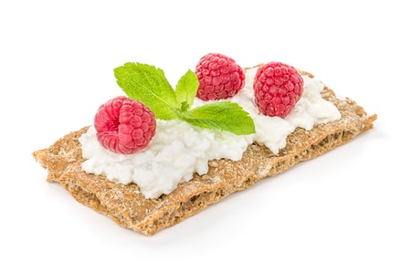 Crispbread with cream cheese and raspberries の写真素材