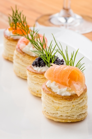 Pastries with salmon, caviar and shrimpの写真素材