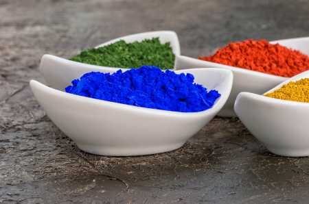 Vibrant color pigments  in porcelain bowls の写真素材