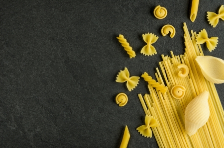 Different types of pasta on a slate backgroundの写真素材