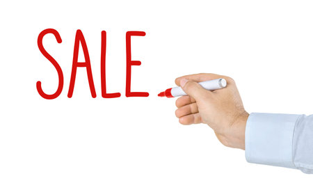 Hand with pen writing the word Saleの写真素材