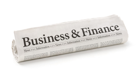 Rolled newspaper with the headline Business and Financeの写真素材