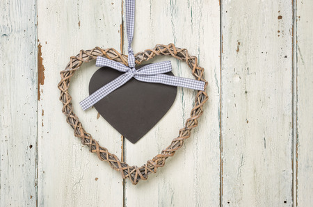 Braided heart with a sign on a white wooden backgroundの写真素材