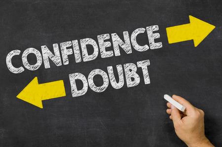 Confidence or Doubt written on a blackboardの写真素材