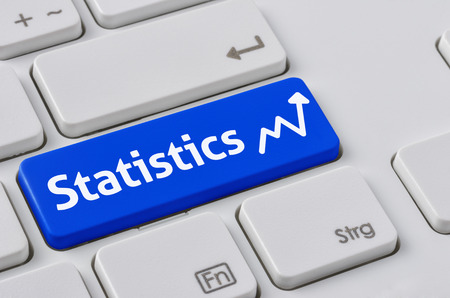 A keyboard with a blue button - Statisticsの写真素材