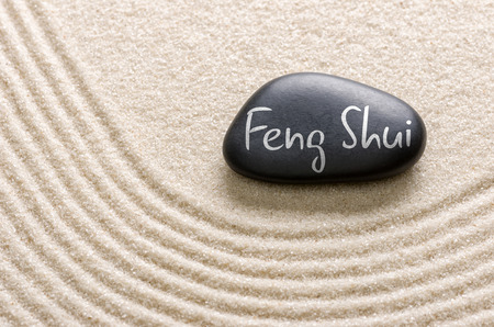 A black stone with the inscription Feng Shuiの写真素材