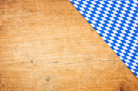 A wooden background with a bavarian table clothの写真素材