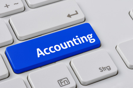 A keyboard with a blue button - Accountingの写真素材