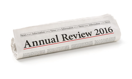 Rolled newspaper with the headline Annual review 2016の写真素材