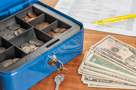 A cash box with banknotes and coinsの写真素材