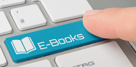 A keyboard with a blue labeled button - E-Booksの写真素材