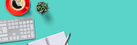 Top view of a workplace with office supplies on a turquoise background