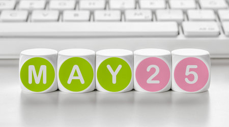 Letter dice in front of a keyboard - May 25