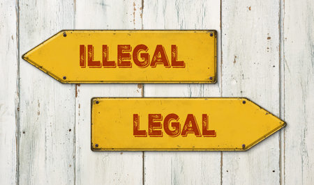 Direction signs on a wooden wall - Illegal or Legalの写真素材