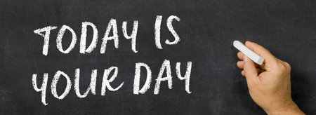 Text written on a blackboard - Today is your dayの写真素材