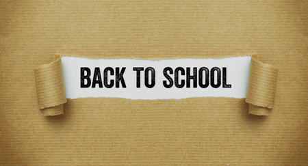 Torn paper revealing the words Back to schoolの写真素材