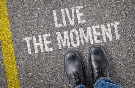 Text on the road - Live the momentの写真素材