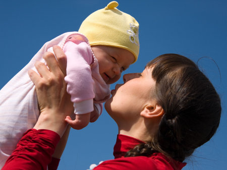 Baby with mom on blue sky background