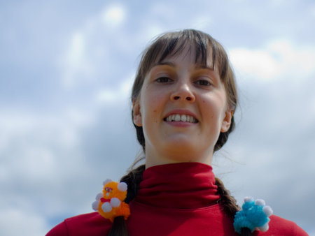 Smiling girl on the sky backgroundの写真素材