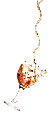 Goblet pouring with a splashing cola - isolated on whiteの写真素材