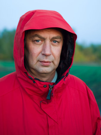 Portrait of man in red jacket outdoors