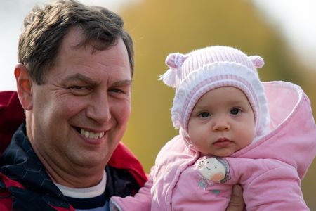 Happy grandfather with granddaughter outdoorsの写真素材