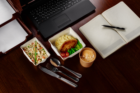 Business lunch on the desktop of the computer on one personの写真素材