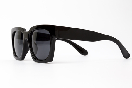 Cool sunglasses with black plastic frame isolated on white background.の写真素材